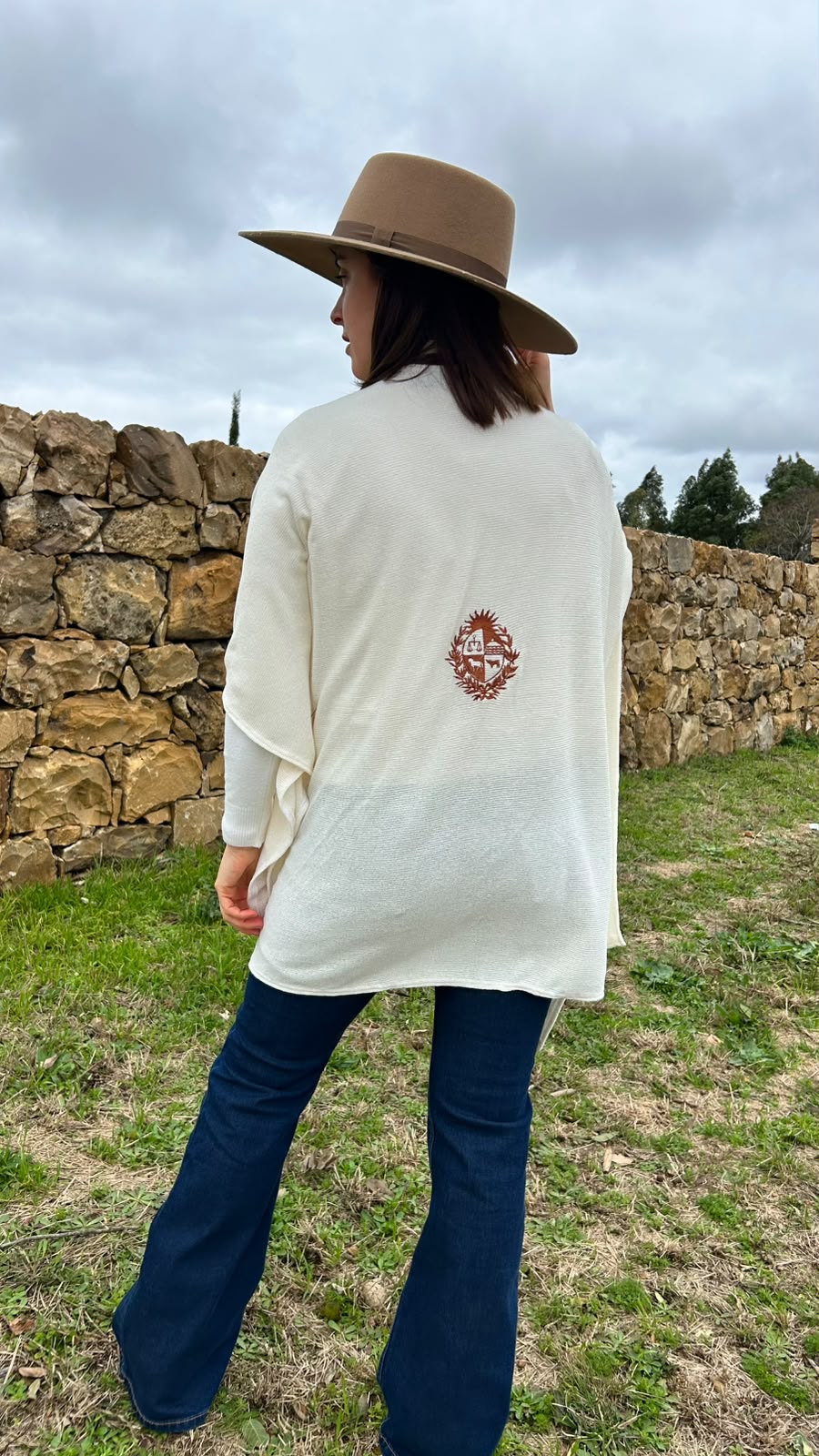 RUANA DE HILO CON ESCUDO BORDADO EN MARRÓN